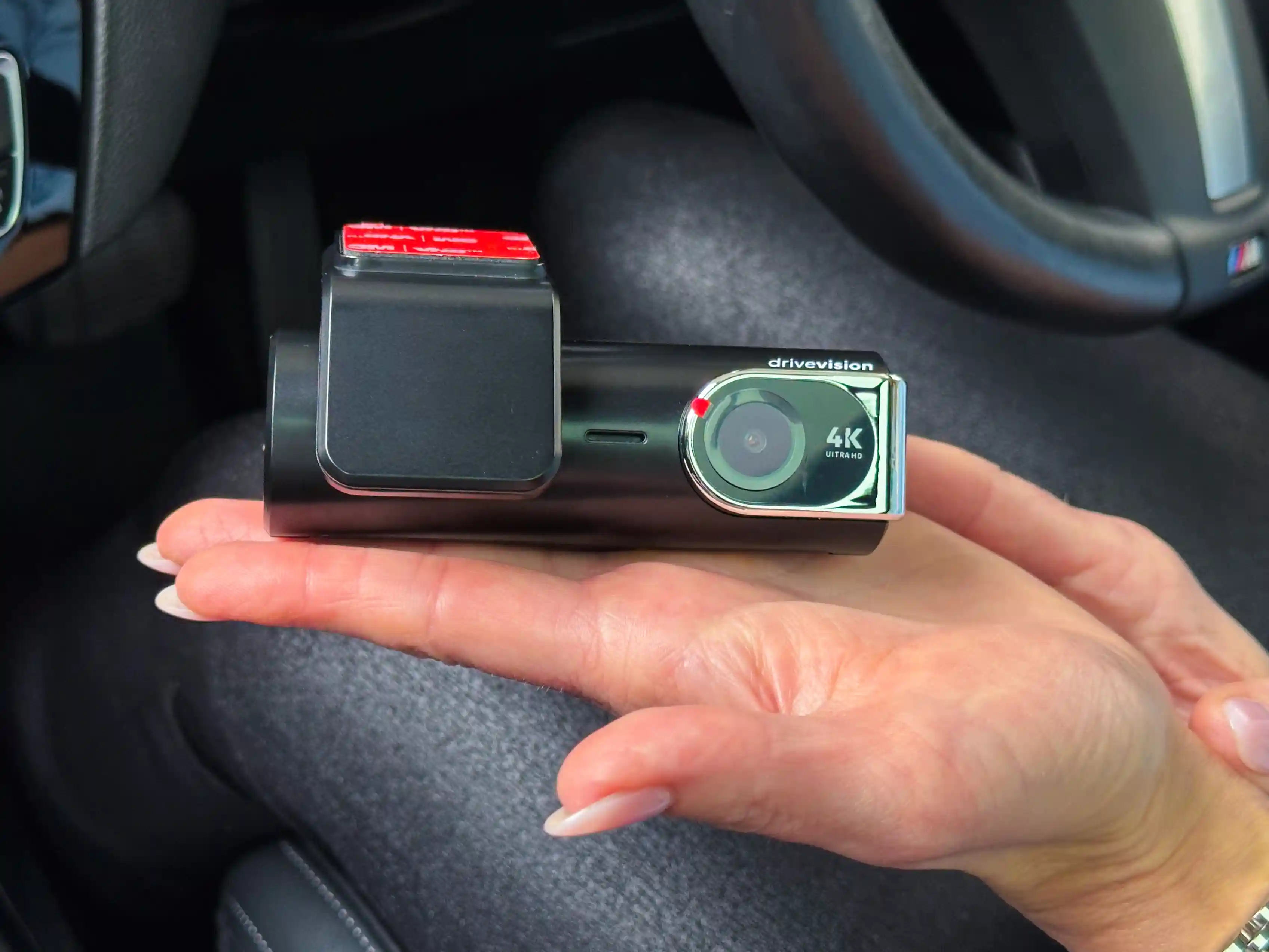 DriveVision 4K Dash Cam in matte black finish held in woman’s hand – sleek Australian dash cam 2025